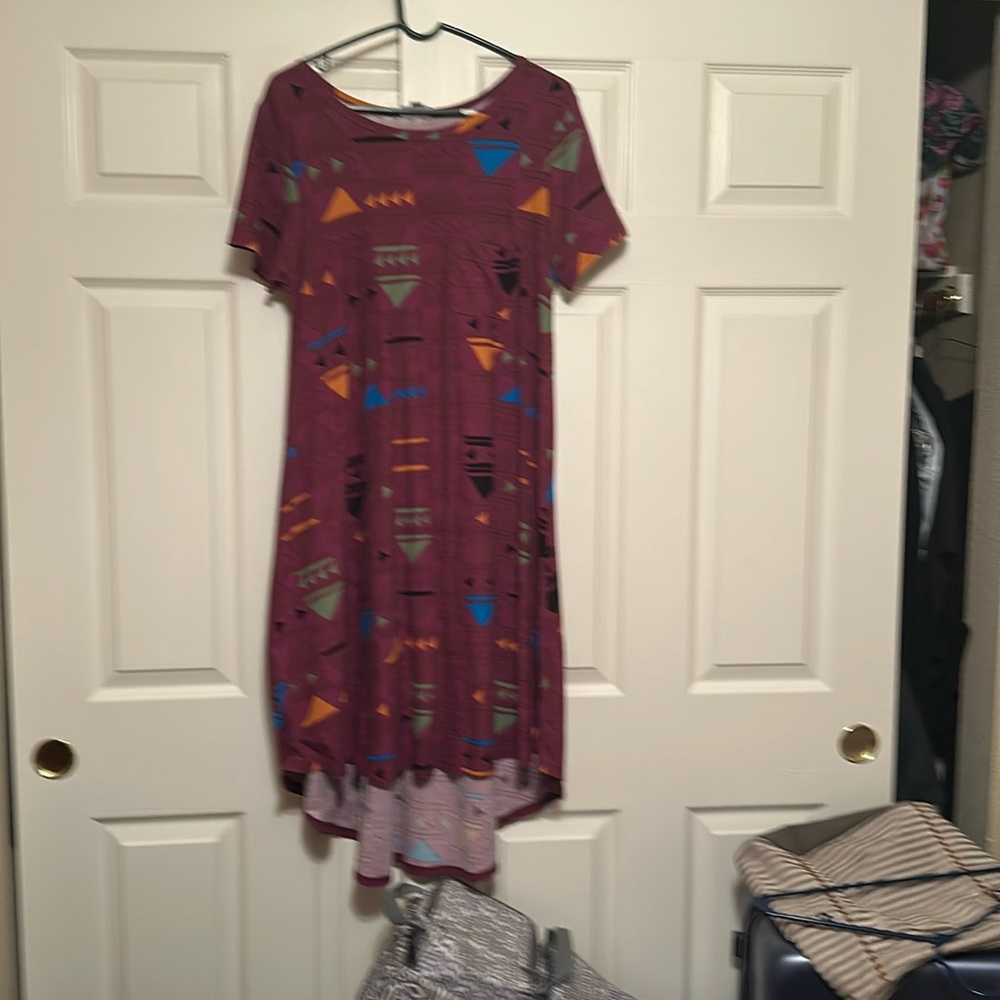 Carly Dress, leggings material the background is a plum color.